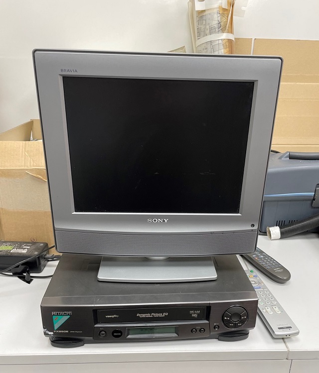 A television sits on top of a VHS video player