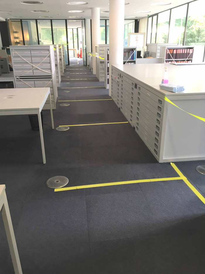Room with tables and cabinets and yellow tape marking areas as off limits