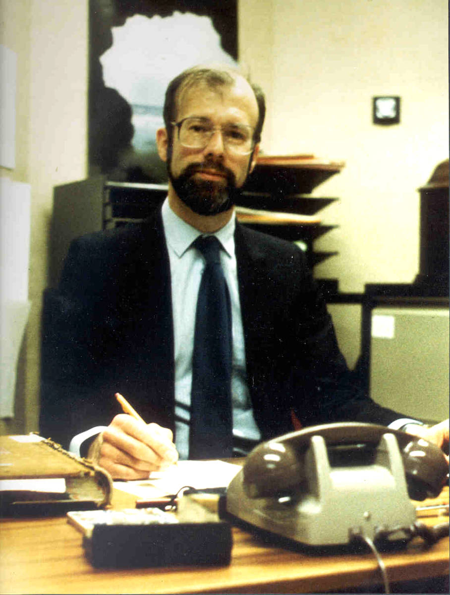 Adam Green County Archivist of the RBA 1983 to 1988 sitting at a desk.