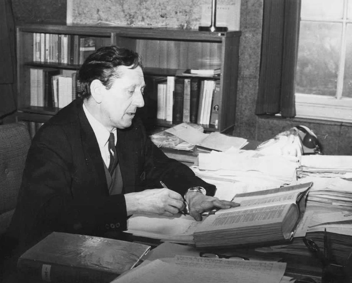 Peter Walne County Archivist of the RBA 1952 to 1962 sits a a desk. Photograph courtesy of Hertfordshire Archives and Local Studies.